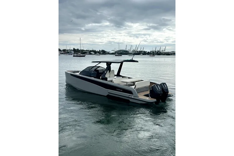 Virtue Yacht Photos Pics 2026 Virtue V10 boat on calm water, overcast sky, modern design.