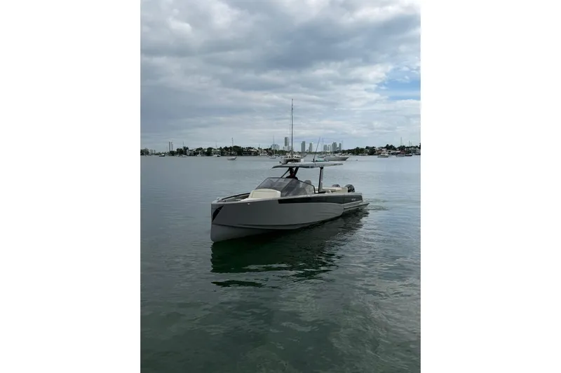 Virtue Yacht Photos Pics 2026 Virtue V10 boat on calm water under cloudy sky.