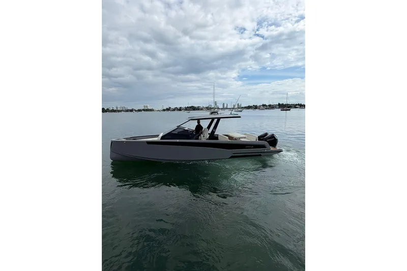Virtue Yacht Photos Pics 2026 Virtue V10 boat cruising on calm waters under a cloudy sky.