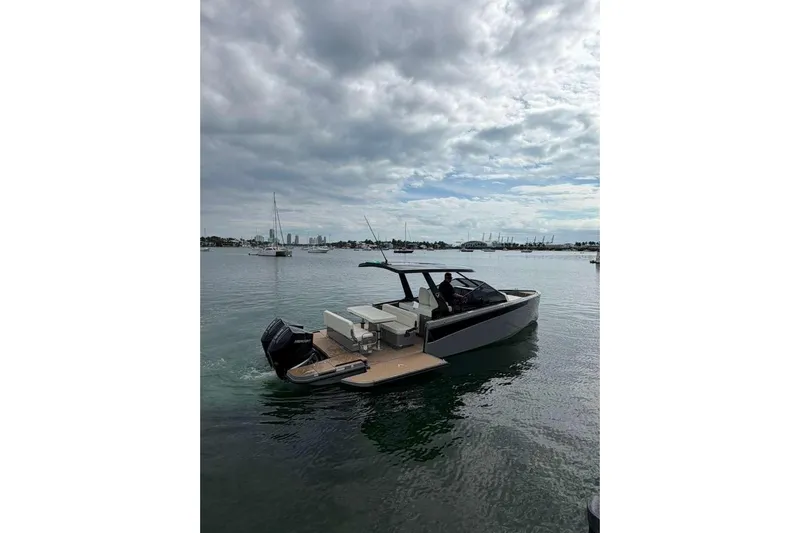 Virtue Yacht Photos Pics Virtue V10 2026 boat on calm water under cloudy sky, featuring sleek design.