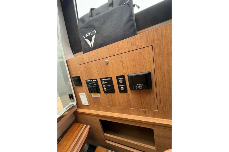Virtue Yacht Photos Pics Control panel of 2026 Virtue V10 with wood finish and electronic displays.
