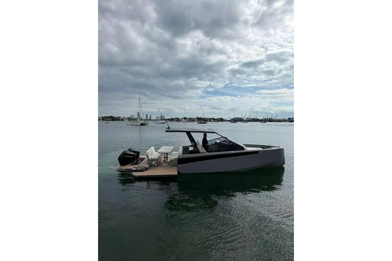 Virtue Yacht Photos Pics 2026 Virtue V10 boat on calm water under cloudy sky.