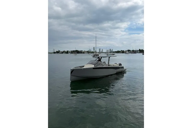 Virtue Yacht Photos Pics 2026 Virtue V10 boat on calm water under cloudy sky.