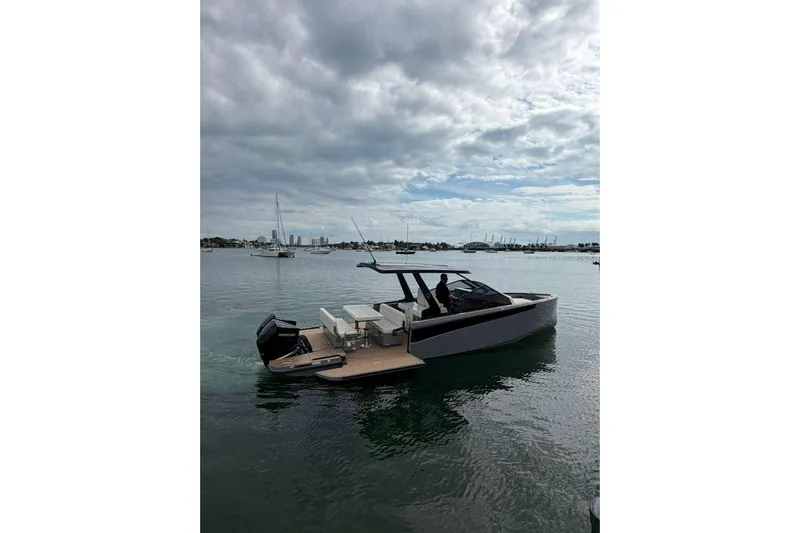 Virtue Yacht Photos Pics 2026 Virtue V10 boat on calm water under cloudy sky.