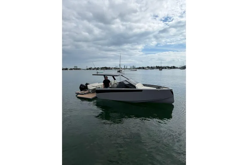 Virtue Yacht Photos Pics 2026 Virtue V10 boat on calm water under cloudy sky.