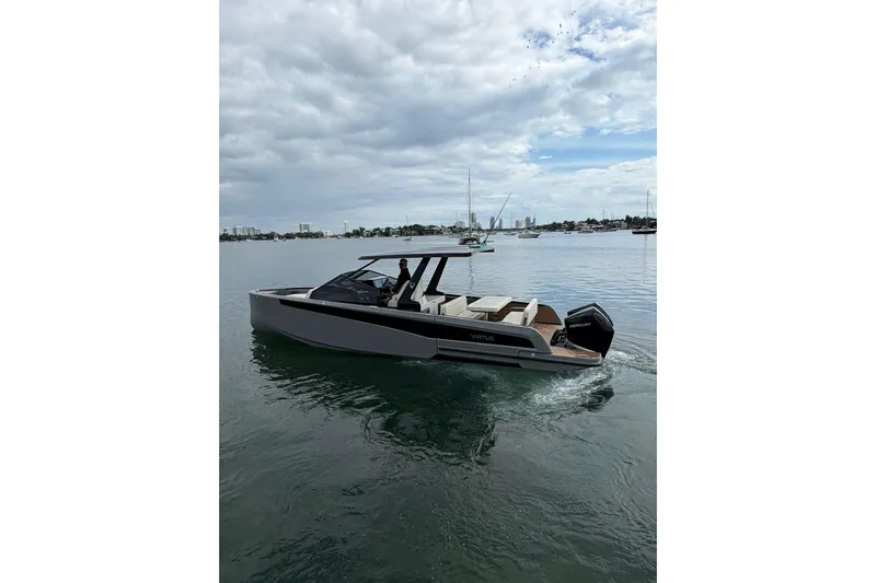 Virtue Yacht Photos Pics 2026 Virtue V10 boat cruising on calm waters under a cloudy sky.