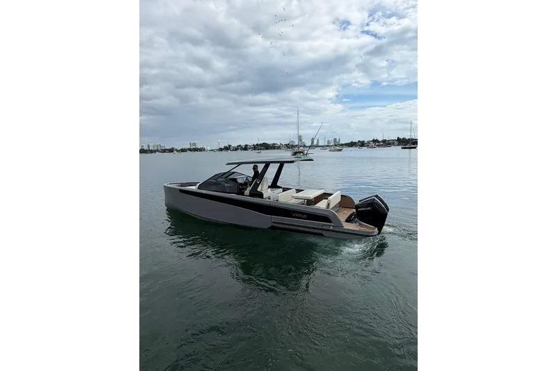 Virtue Yacht Photos Pics 2026 Virtue V10 boat cruising on calm waters under a cloudy sky.