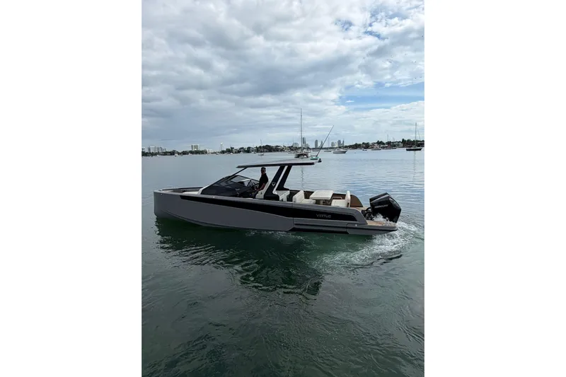 Virtue Yacht Photos Pics Modern 2026 Virtue V10 boat cruising on calm waters under a cloudy sky.