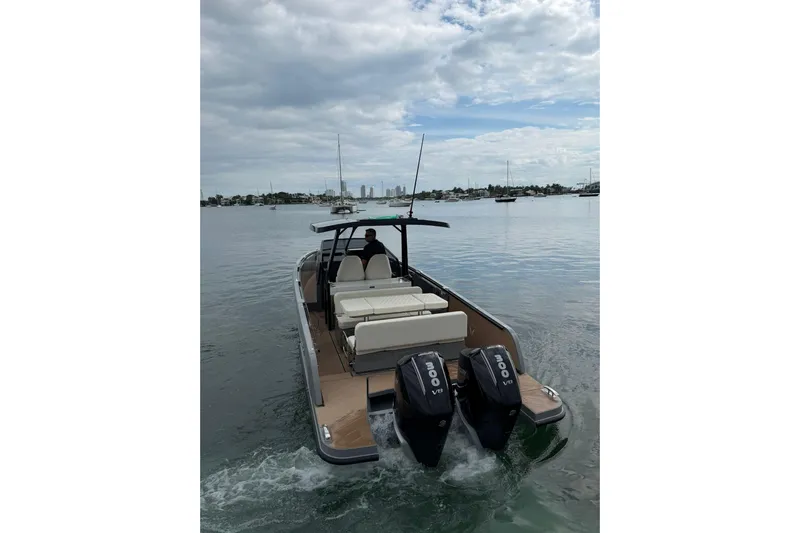 Virtue Yacht Photos Pics 2026 Virtue V10 boat with dual engines cruising on a calm waterway.