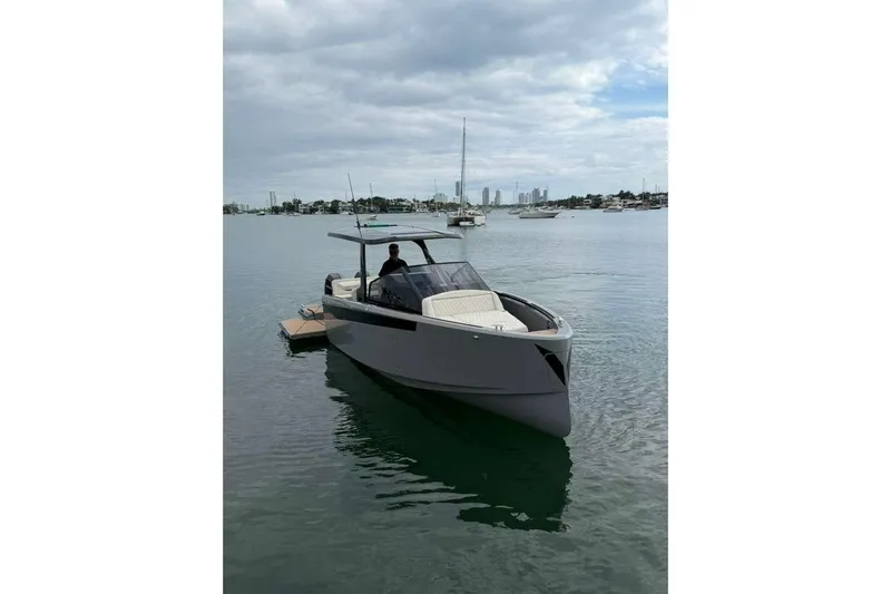 Virtue Yacht Photos Pics Luxury 2026 Virtue V10 boat on calm waters, with city skyline in background.