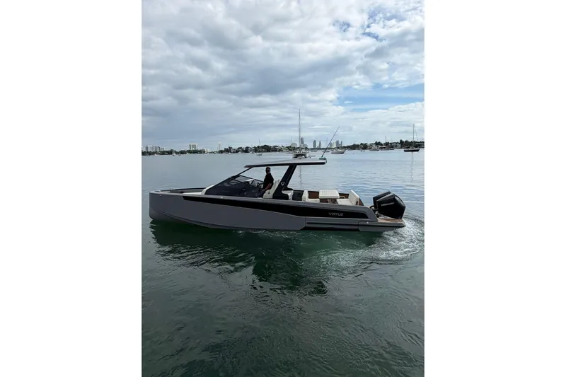Virtue Yacht Photos Pics 2026 Virtue V10 boat cruising on calm waters under a cloudy sky.