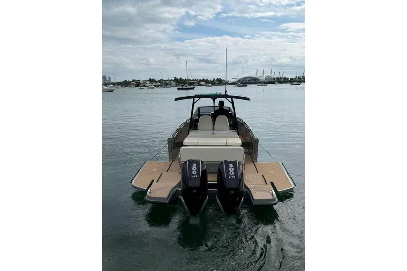 Virtue Yacht Photos Pics Virtue V10 2026 boat with dual engines on calm water, scenic marina backdrop.