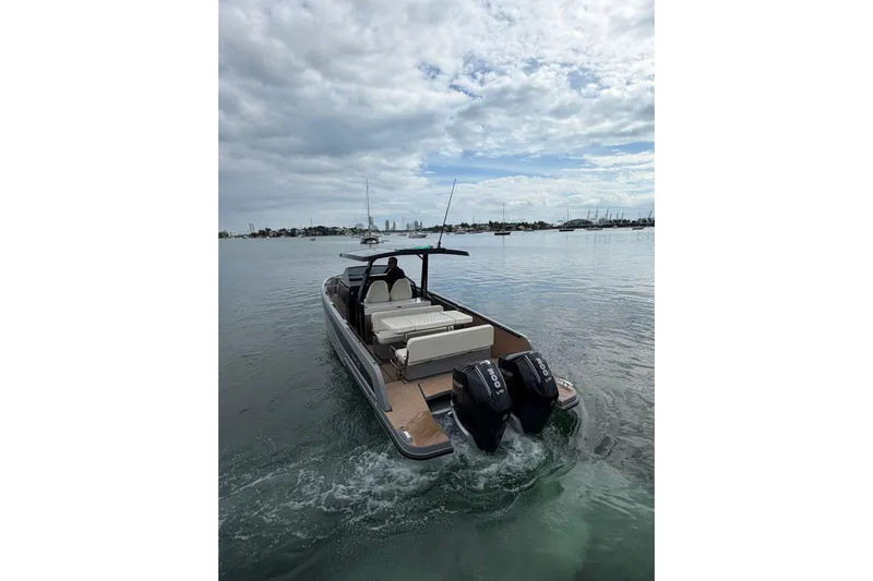 Virtue Yacht Photos Pics Modern 2026 Virtue V10 boat cruising on calm waters under a cloudy sky.