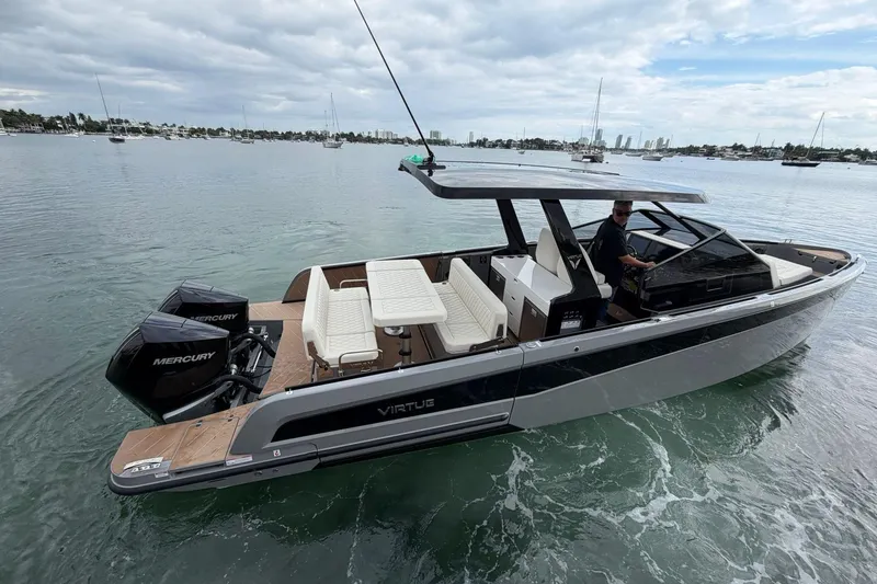 Virtue Yacht Photos Pics 2026 Virtue V10 boat on water, featuring sleek design and dual Mercury engines.