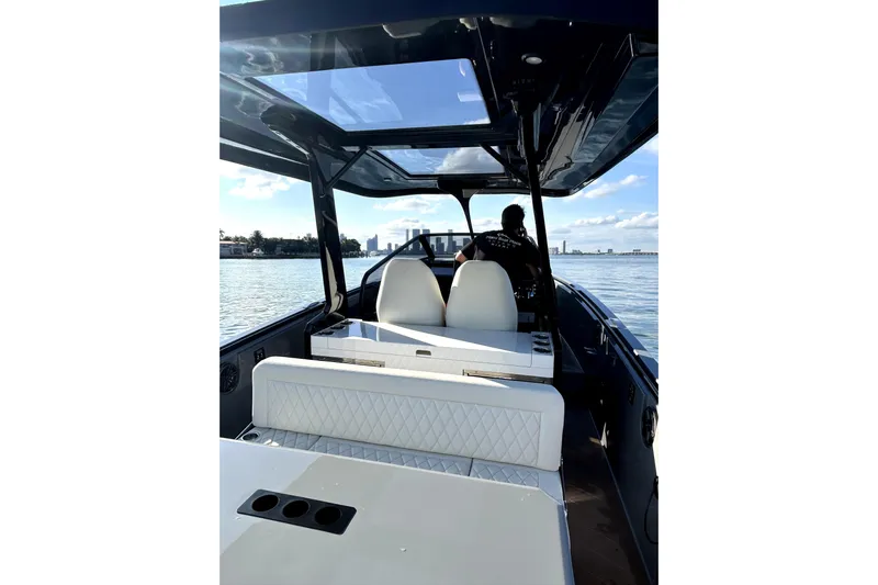 Virtue Yacht Photos Pics Luxurious 2026 Virtue V10 boat interior with white seating and panoramic water view.