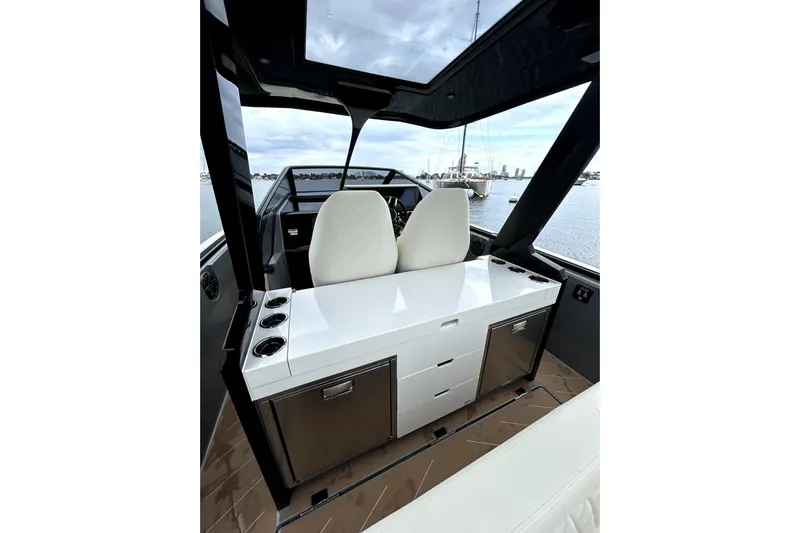 Virtue Yacht Photos Pics Luxurious interior of 2026 Virtue V10 boat with sleek white seating and cabinetry.