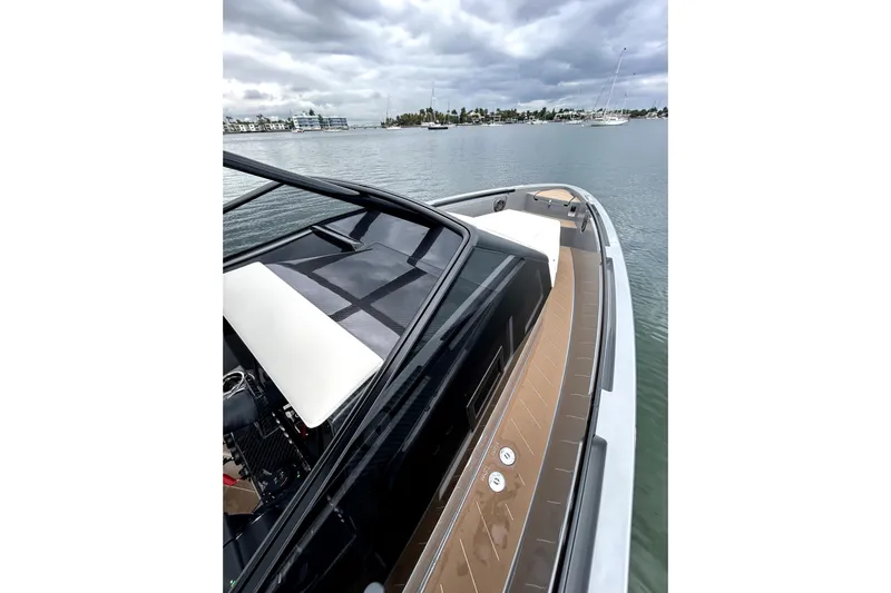 Virtue Yacht Photos Pics Luxurious 2026 Virtue V10 yacht on calm waters under cloudy skies.