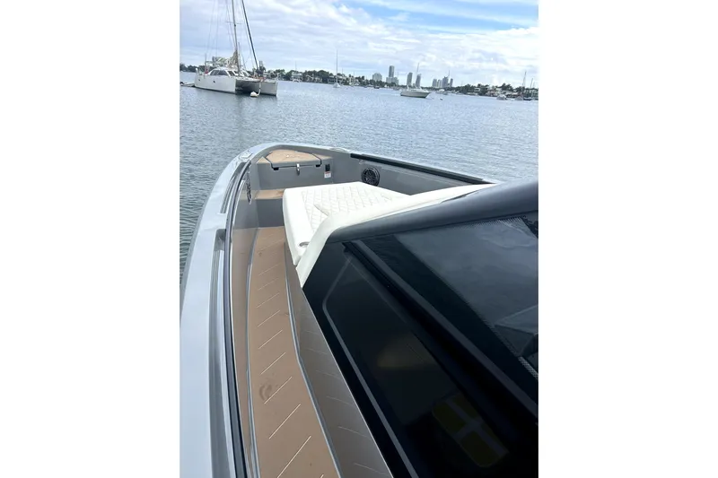 Virtue Yacht Photos Pics 2026 Virtue V10 boat on calm water with city skyline in background.