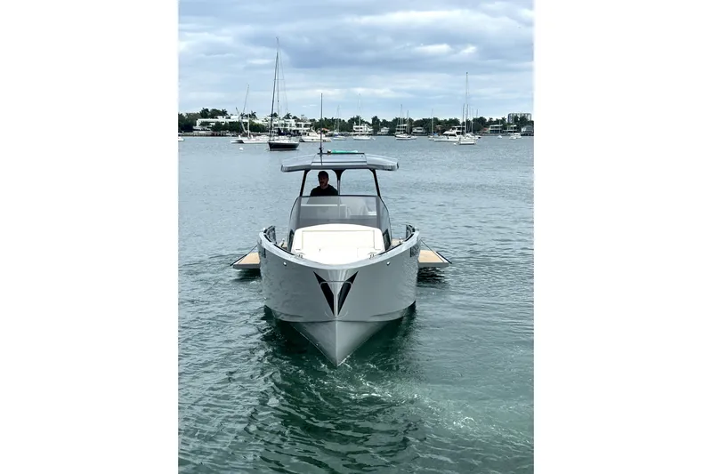 Virtue Yacht Photos Pics 2026 Virtue V10 boat on calm water, with a modern design and sleek structure.