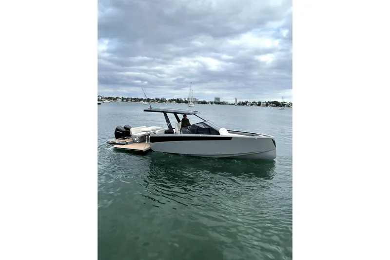 Virtue Yacht Photos Pics 2026 Virtue V10 boat on calm water under cloudy sky.
