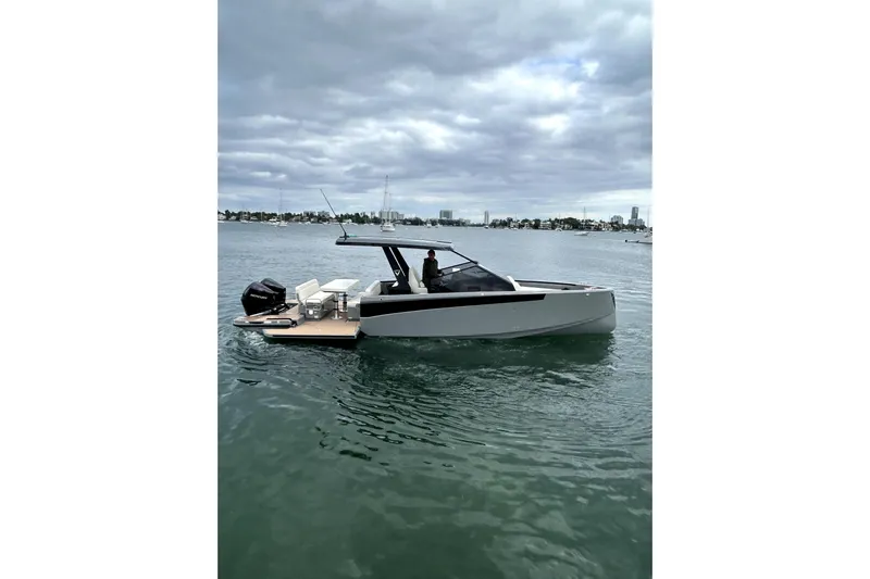 Virtue Yacht Photos Pics 2026 Virtue V10 boat on calm water under cloudy sky.