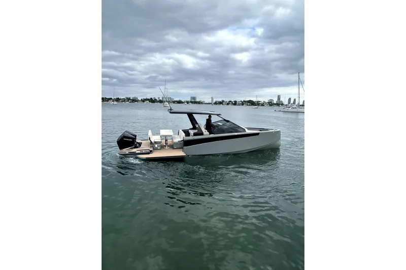 Virtue Yacht Photos Pics 2026 Virtue V10 boat on calm water under cloudy sky.