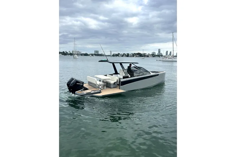 Virtue Yacht Photos Pics 2026 Virtue V10 boat cruising on a calm waterway under cloudy skies.