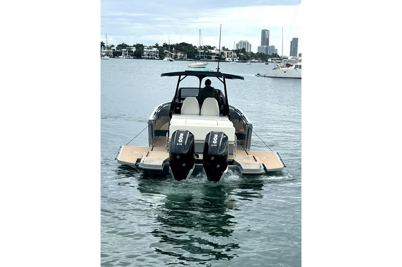 Virtue Yacht Photos Pics 2026 Virtue V10 boat with dual engines cruising in a scenic harbor.