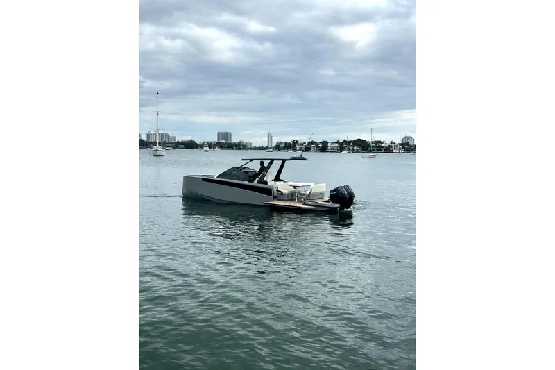 Virtue Yacht Photos Pics Modern 2026 Virtue V10 boat on calm water under cloudy sky.