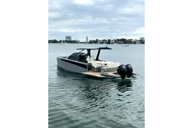 Virtue Yacht Photos Pics 2026 Virtue V10 boat on calm water, featuring sleek design and dual outboard motors.