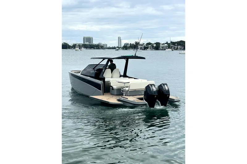 Virtue Yacht Photos Pics 2026 Virtue V10 boat on water, featuring dual outboard motors and sleek design.