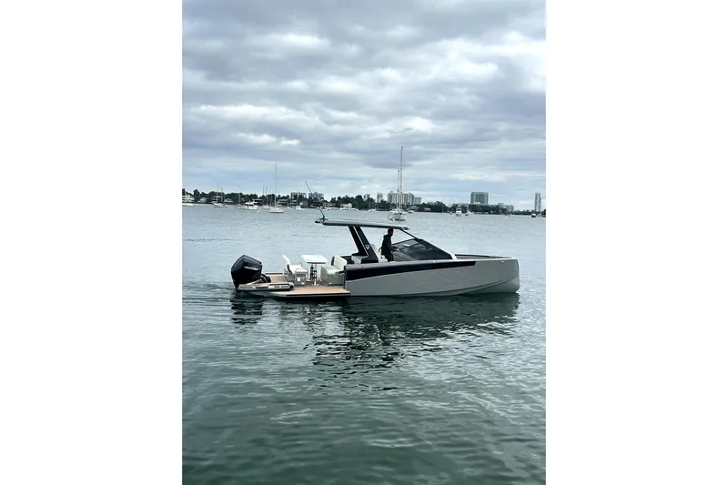 Virtue Yacht Photos Pics 2026 Virtue V10 boat on calm water under cloudy sky.
