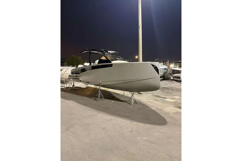 Virtue Yacht Photos Pics 2026 Virtue V10 boat displayed outdoors at night, elevated on stands.