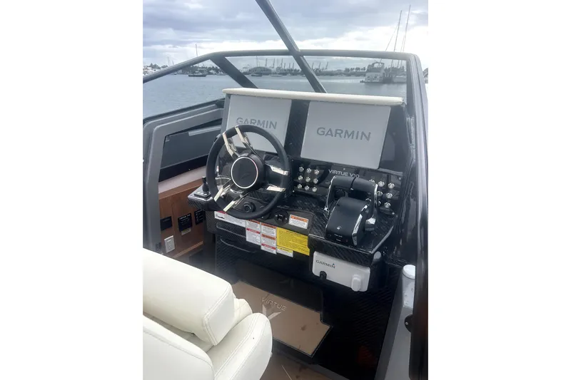 Virtue Yacht Photos Pics 2026 Virtue V10 boat dashboard with Garmin navigation, steering wheel, and controls.