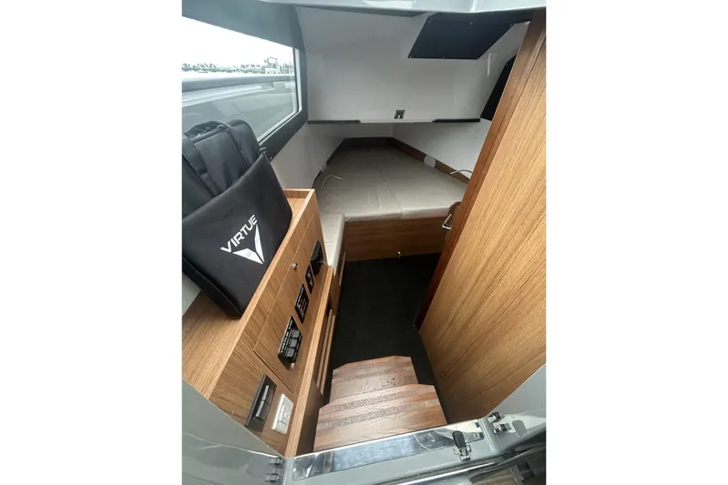 Virtue Yacht Photos Pics Interior of 2026 Virtue V10 cabin with wooden finish and compact sleeping area.