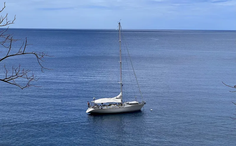 Sv Mototi Yacht Photos Pics Sailboat Nautor Swan 46 (1991) anchored in calm blue sea, under clear sky.