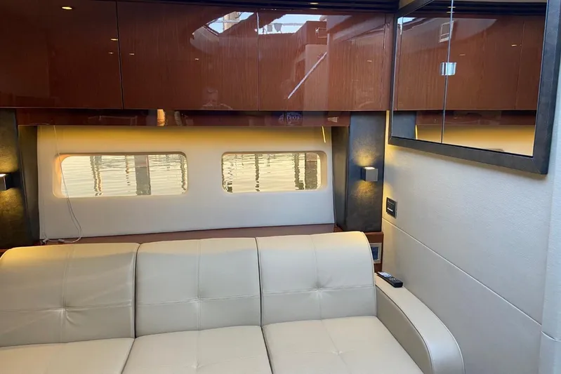 Godsend Yacht Photos Pics Luxurious interior of 2015 Sea Ray 470 Sundancer yacht with beige seating and wooden cabinets.
