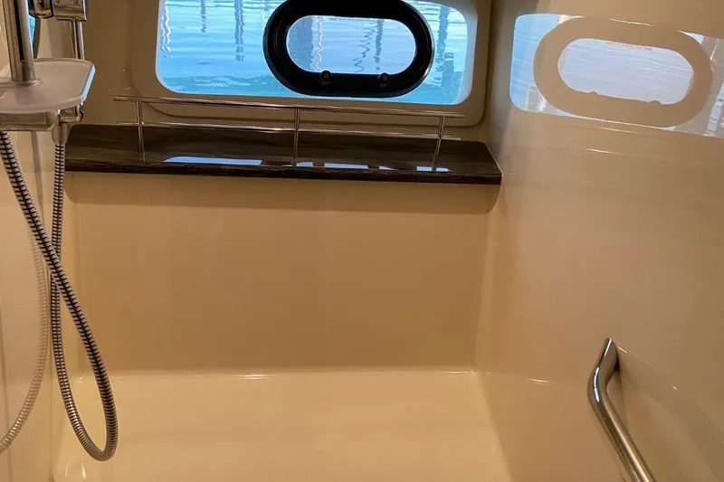 Godsend Yacht Photos Pics Luxurious bathroom interior of 2015 Sea Ray 470 Sundancer yacht with window view.