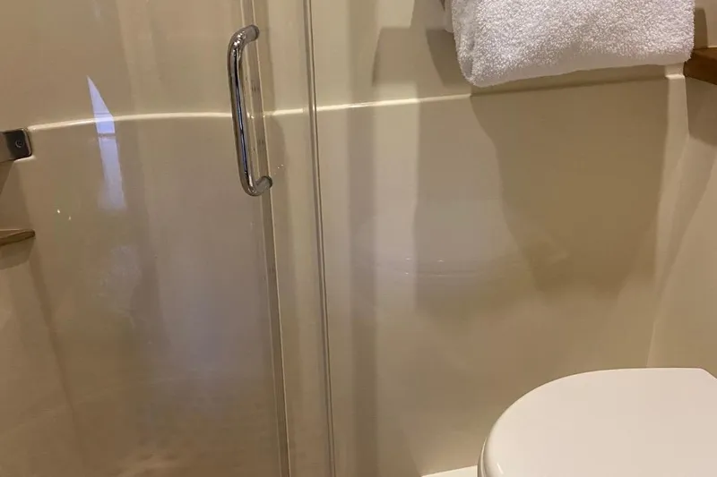 Godsend Yacht Photos Pics Bathroom interior of 2015 Sea Ray 470 Sundancer yacht with shower and towel.