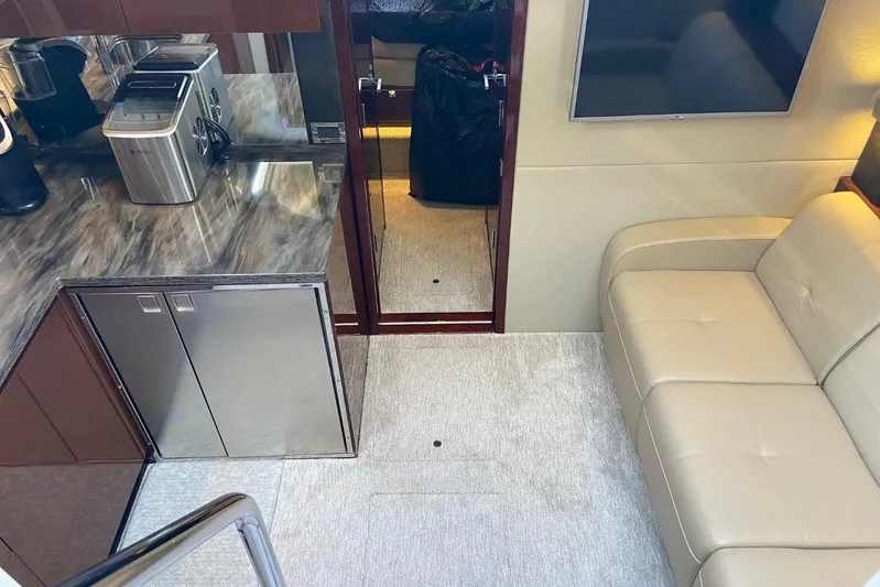 Godsend Yacht Photos Pics Interior of 2015 Sea Ray 470 Sundancer yacht with modern kitchen and beige sofa.