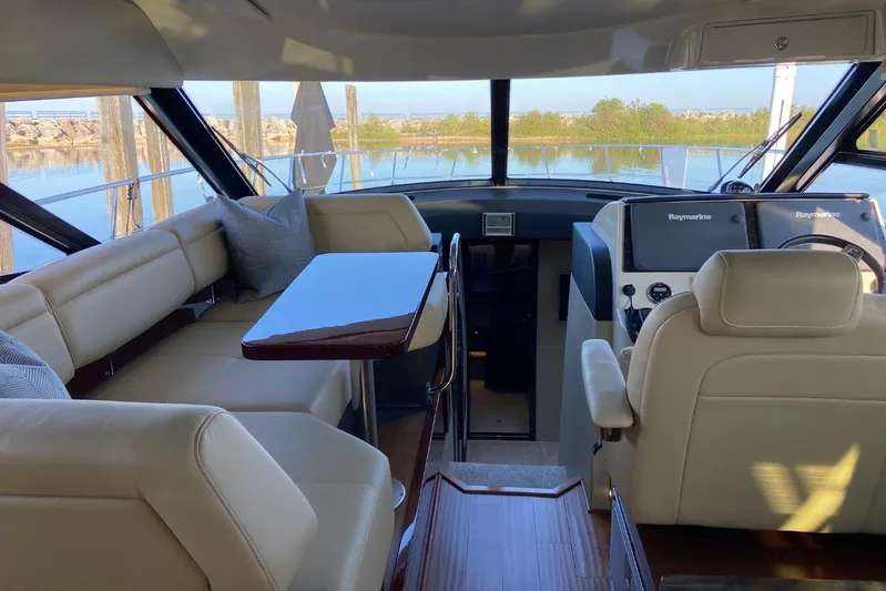 Godsend Yacht Photos Pics Luxurious interior of 2015 Sea Ray 470 Sundancer yacht with plush seating and navigation controls.