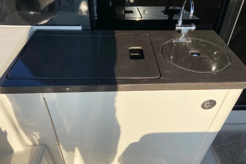 Godsend Yacht Photos Pics Outdoor kitchenette on 2015 Sea Ray 470 Sundancer yacht with sink and countertop.