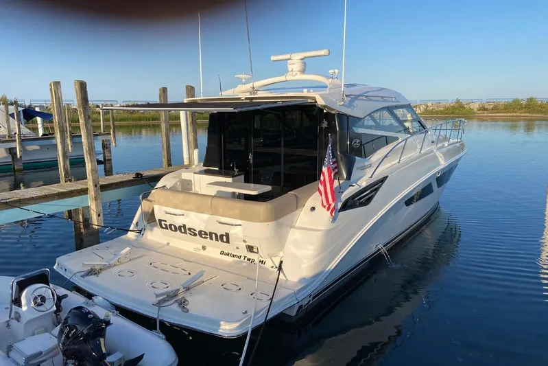 Godsend Yacht Photos Pics 2015 Sea Ray 470 Sundancer yacht docked, featuring sleek design and American flag.