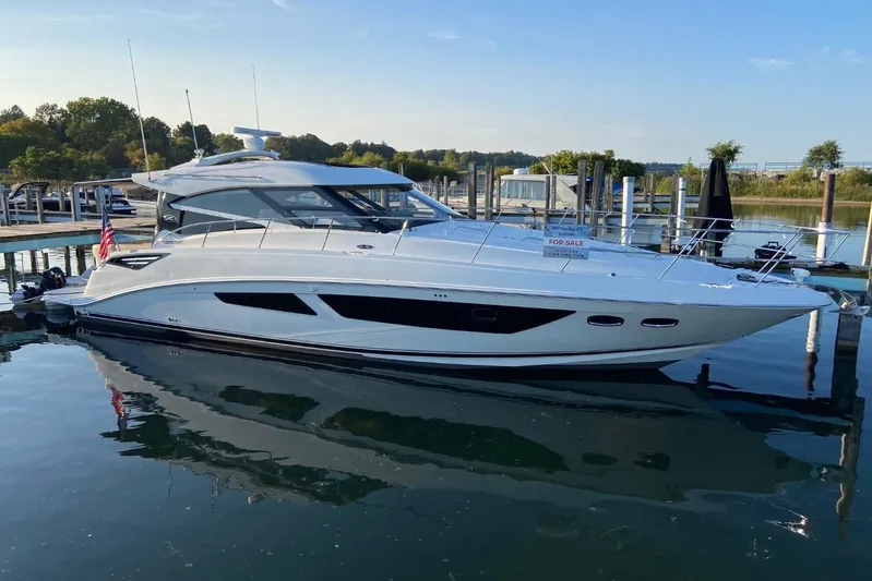 Godsend Yacht Photos Pics 2015 Sea Ray 470 Sundancer yacht docked, for sale, reflecting on calm water.