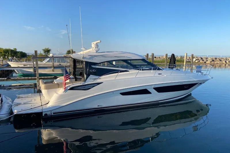 Godsend Yacht Photos Pics 2015 Sea Ray 470 Sundancer yacht docked in a serene marina setting.