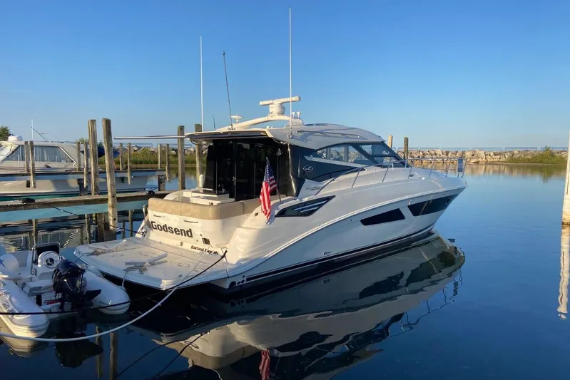 Godsend Yacht Photos Pics 2015 Sea Ray 470 Sundancer yacht docked in a serene marina setting.