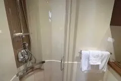 Godsend Yacht Photos Pics Shower area in 2015 Sea Ray 470 Sundancer yacht bathroom with glass door and towel rack.