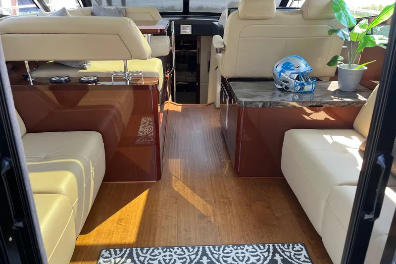Godsend Yacht Photos Pics Luxurious interior of 2015 Sea Ray 470 Sundancer with leather seating and wooden flooring.