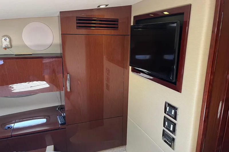 Godsend Yacht Photos Pics Luxurious interior of 2015 Sea Ray 470 Sundancer yacht with TV and wooden cabinetry.