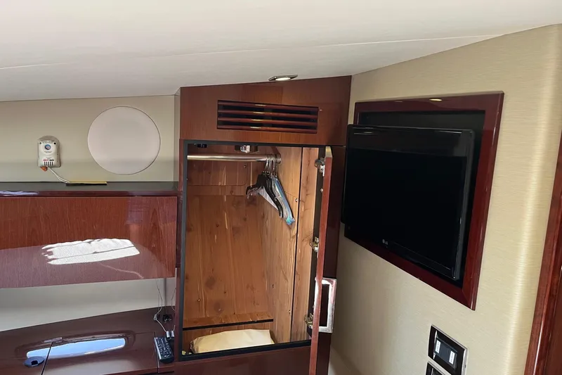 Godsend Yacht Photos Pics 2015 Sea Ray 470 Sundancer interior with wooden closet and wall-mounted TV.